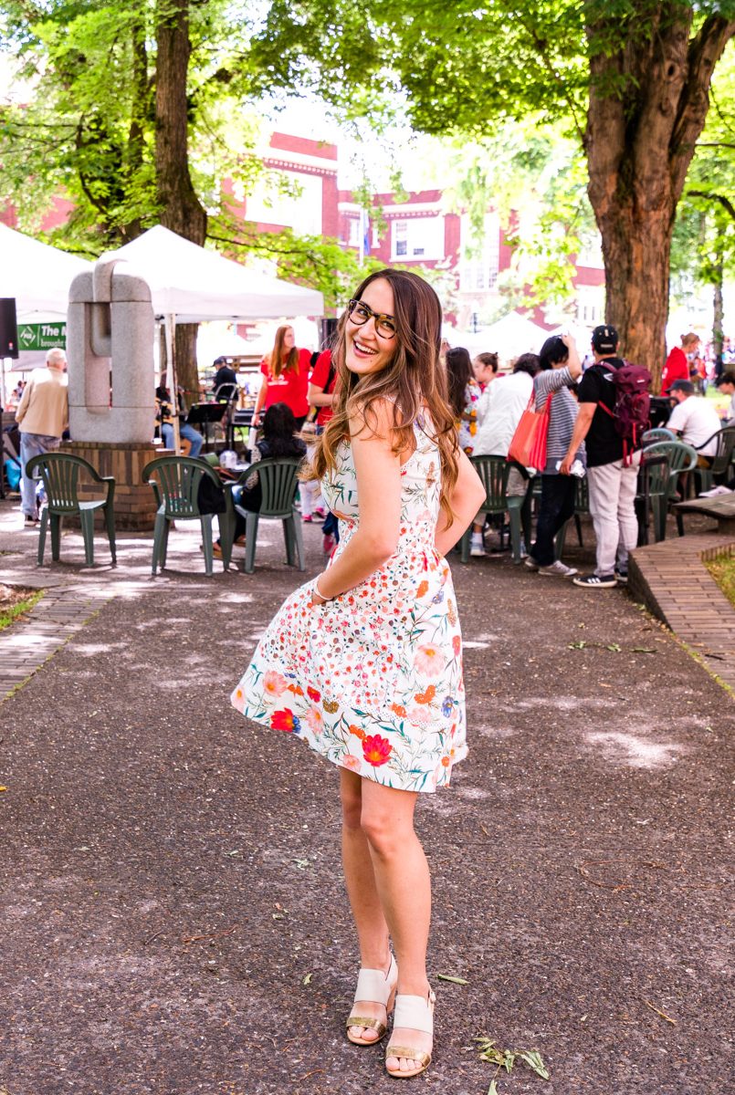 Antonina in a floral dress at the Portland State University Farmers Market under the trees
