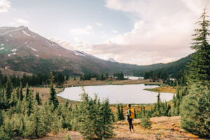 A hiker above Green Lakes