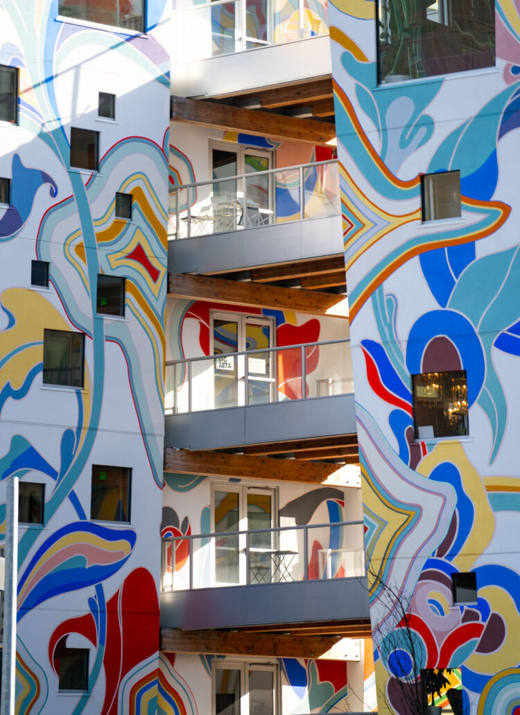 Colorful painted facade of the Fair-Haired Dumbbell building in Portland with balconies and bold abstract shapes