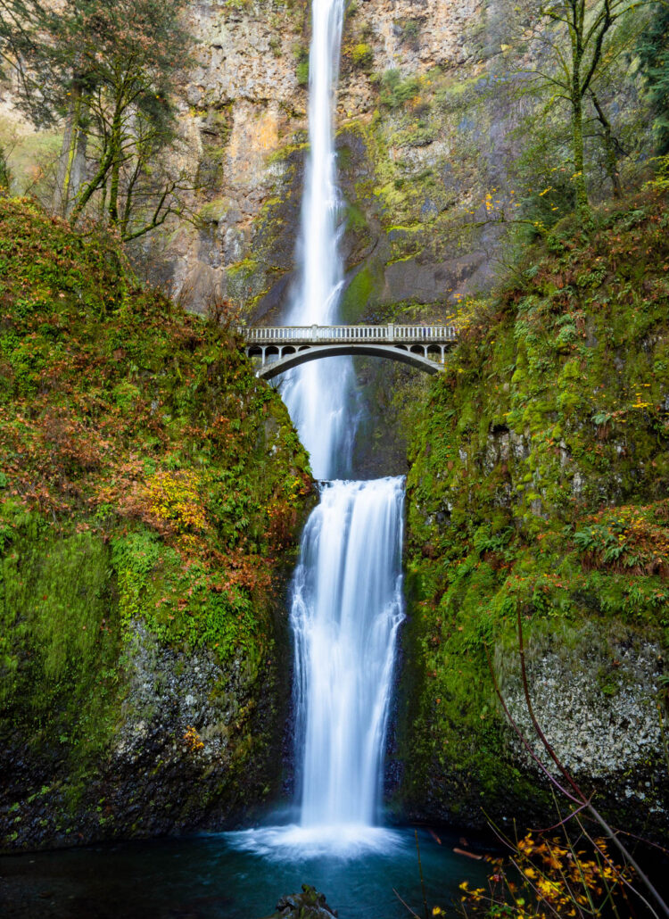 Multnomah Falls and Benson Bridge with autumn color on the mossy cliffs