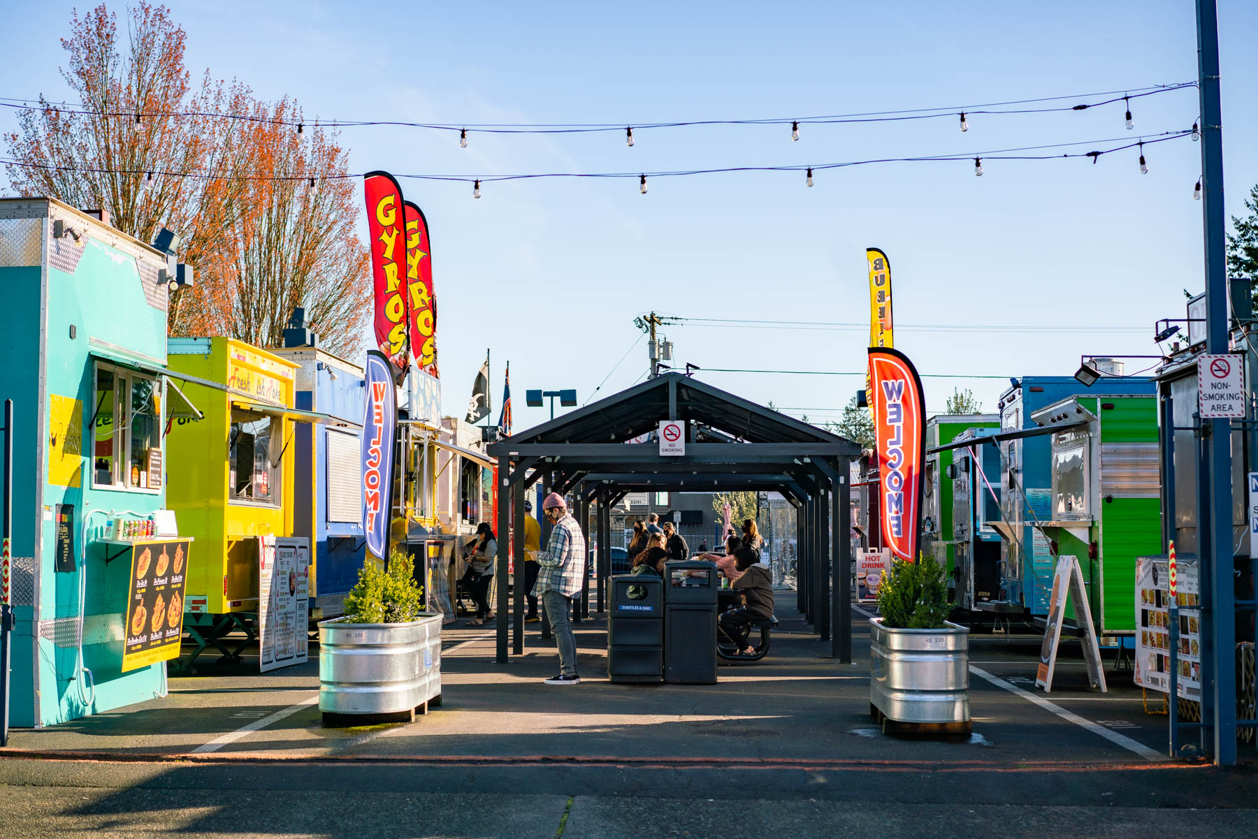A Portland food cart pod with rows of trucks and string lights