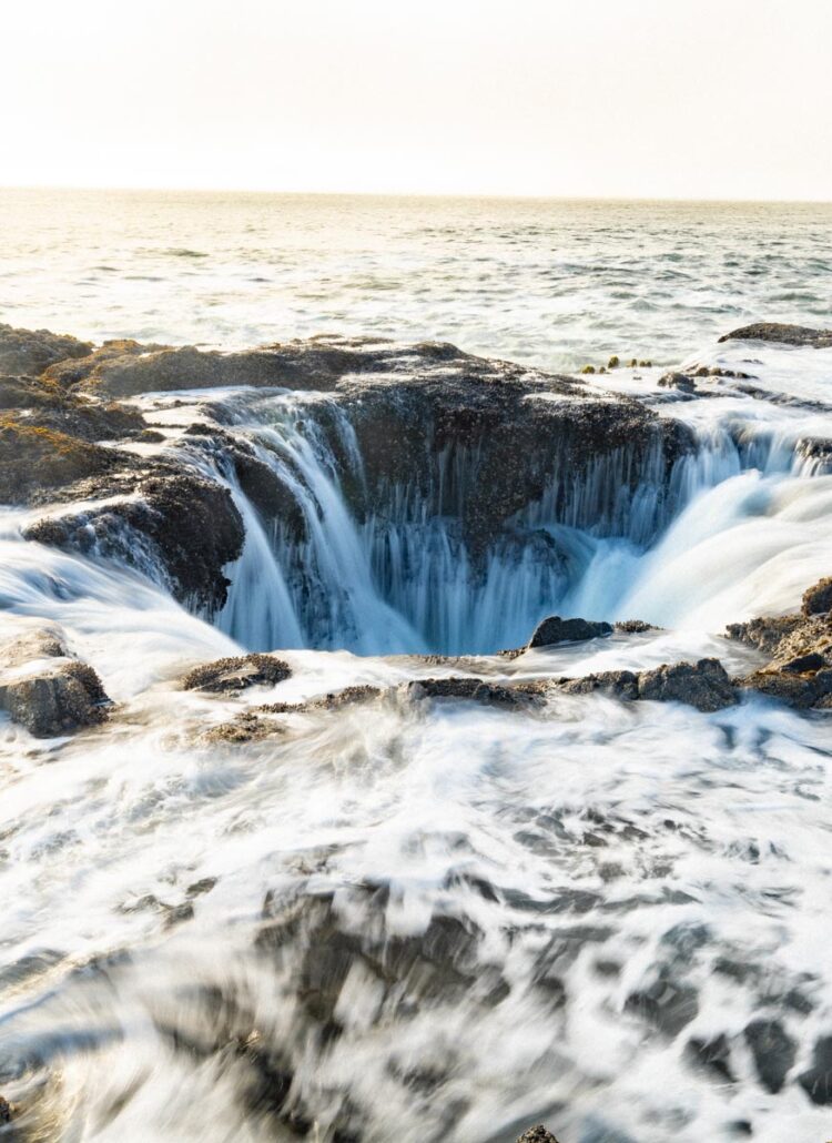 Thor's Well at Cape Perpetua with the tide surging over the basalt