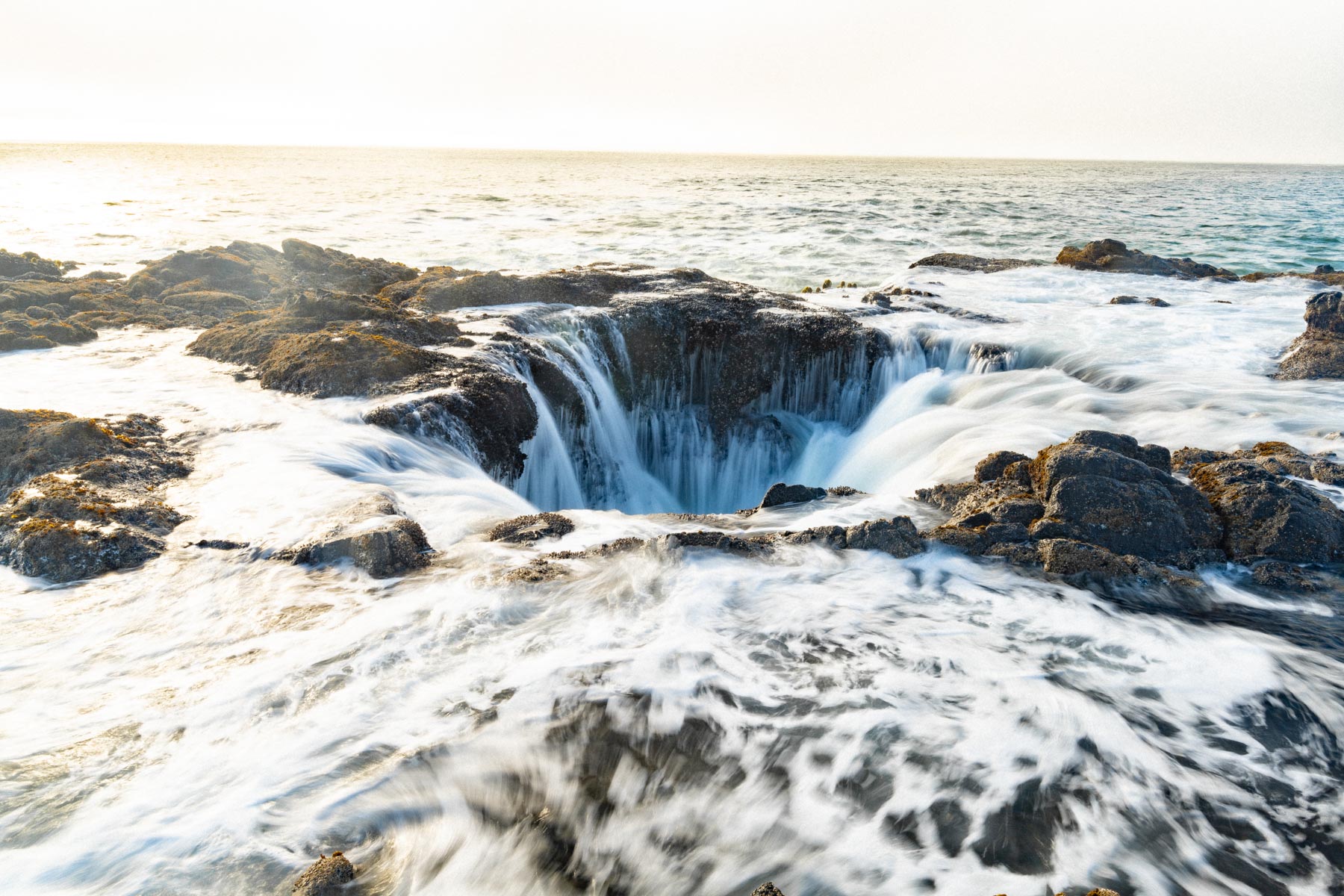 Thor's Well at Cape Perpetua with the tide surging over the basalt