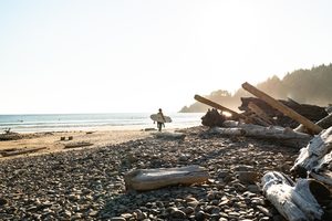 A surfer on the beach at Oswald West State Park